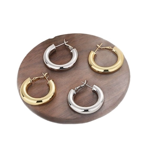 Minimalist 18K gold and silver chunky hoop earrings set with a mirror polished finish