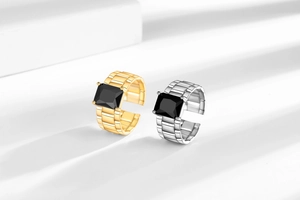 Detail of vintage rectangle black zircon rings with industrial oyster strap metal band