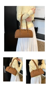 Detail view of a vintage brown leather baguette tote bag with stylish contrast stitching