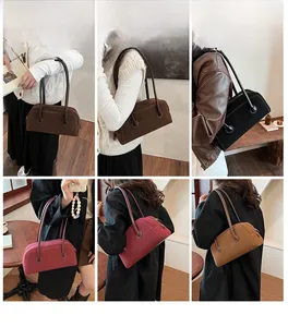 Detail view of retro suede Boston shoulder bags in multiple colors for women