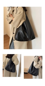 Close-up of minimalist black PU leather tote showing texture and shoulder carry style