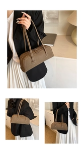 Detail of vintage minimalist faux leather tote with elegant white contrast stitching