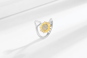 Detail of spinning sunflower ring with You are my sunshine engraving and crystal inlay