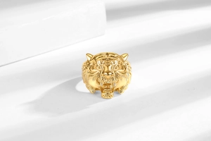 Macro shot of gold tiger head ring showing intricate facial textures and polished finish
