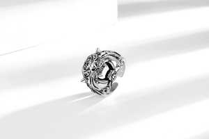 Detailed view of silver tiger head ring with antique texture and adjustable open band