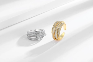 Detailed view of luxury silver and gold layered adjustable rings with cubic zirconia stones
