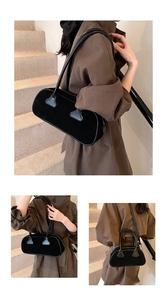 Detail of vintage matte black bowling bag with polished leather handles and slim strap