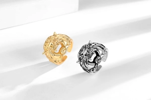 Detailed relief of tiger head rings in gold and silver finishes with open design