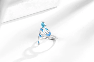 Detailed view of snake-shaped silver ring with blue zircon and light blue enamel detail