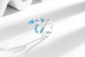 Macro shot of silver snake ring featuring blue zircon head and enamel body details