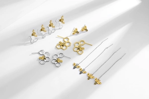 Collection of gold and silver bee earrings with honeycomb studs and long tassel chain links