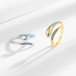 Punk style snake-shaped open rings in gold and silver with blue enamel and gemstones