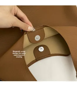 Detail of magnetic snap closure on brown lychee pattern leather tote bag