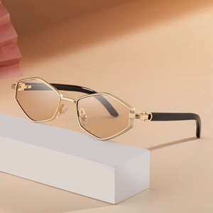 Chic polygonal gold metal sunglasses with light brown lenses on a minimalist display