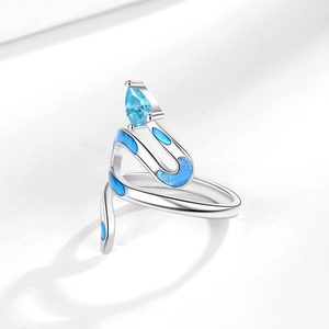 Silver snake ring with light blue zircon head and navy enamel patterns on white background