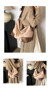 Dettaglio della grande borsa tote in pelle scamosciata con finiture in pelle marrone