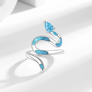 Silver snake wrap ring with blue enamel scales and teardrop zircon on white background