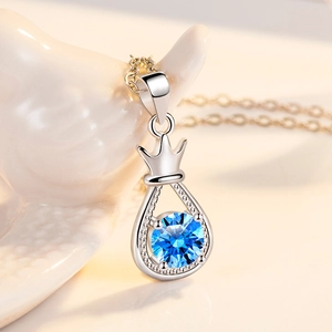 Elegant crown and teardrop pendant necklace with sparkling blue gemstone and silver chain