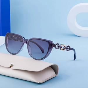 Chic cat eye sunglasses with purple frames, gold chain arms and gradient lenses