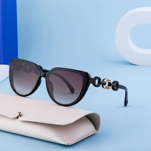 Fashionable black cat-eye sunglasses with gradient lenses and gold chain-link temple detail