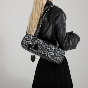 Chic leopard print barrel shoulder bag with black bow and heart charm detail
