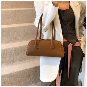 Brown tote bag with contrast stitching detail on model over casual neutral outfit