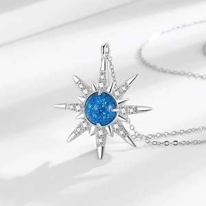 Elegant starburst pendant necklace with deep blue planet stone and sparkling crystals