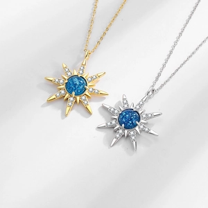 Minimalist starburst necklace set with blue center stone and zircon snowflake pendant