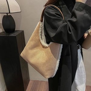 Contrast suede and fleece tote bag with brown leather shoulder strap in a stylish scene