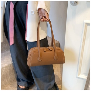Brown faux leather bowling tote bag with contrast stitching and double zipper closure