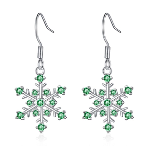 Silver snowflake earrings with green gemstone pavé on a pure white background