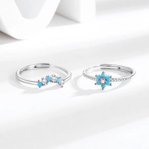 Elegant silver ring set featuring blue turquoise flowers and pearls on white background
