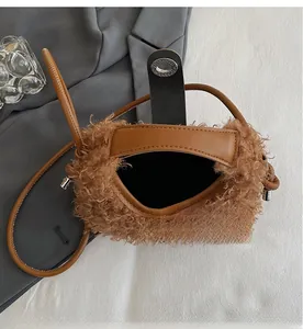 Internal view of plush teddy fabric dumpling bag showing spacious black lining and silver lock