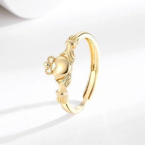Adjustable golden Claddagh ring featuring crown, heart and hands in a minimalist style