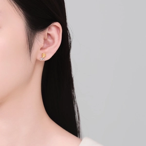 Elegant 3D rose stud earrings in gold and silver finish on model for stylish look