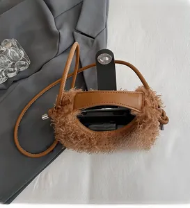 Detailed view of the spacious brown plush bag interior showing phone storage and lock