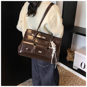 Detailed view of deep brown vintage faux leather messenger bag with silver twist locks