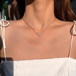 Elegant rose gold horseshoe necklace with micro-paved crystals on female model