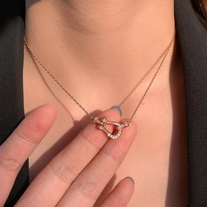 Rose gold horseshoe necklace with micro-pave crystals on a minimalist thin chain
