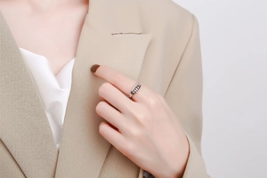 Close-up of interlocking silver spinner ring with pavé zircons on a model's hand