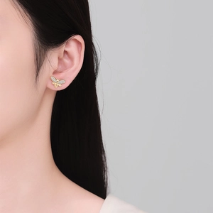 Elegant asymmetrical gold butterfly stud earrings set with sparkling white crystals