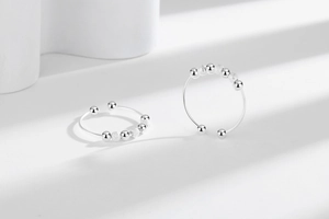 Detail of S925 sterling silver spinning beads on an adjustable fidget ring for anxiety