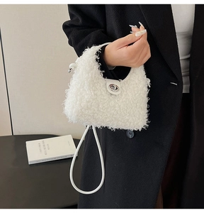 Close-up of white plush teddy faux fur handbag with silver twist lock and round strap