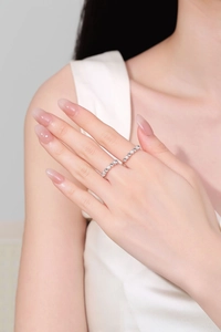 Close-up of S925 sterling silver spinning rings with matte and polished beads on finger