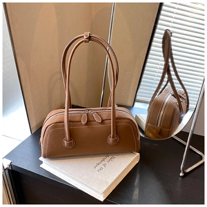 Detail of vintage brown tote bag with white contrast stitching and silver hardware