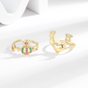 Gold crown and winged heart zircon rings shown from a professional 45-degree angle