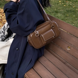 Brown faux leather Boston shoulder bag with white contrast stitching and front flap pocket