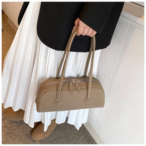 Khaki tote bag styled with blazer, showing large capacity and contrast stitching detail