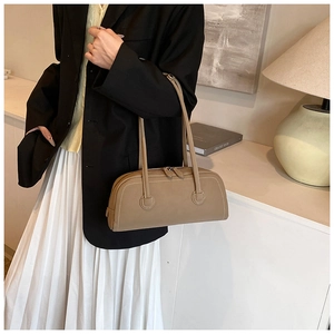 Detail view of khaki baguette tote bag showing white contrast stitching and dual shoulder straps