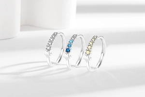 Detailed view of three adjustable silver rings with colorful zircons and star accents